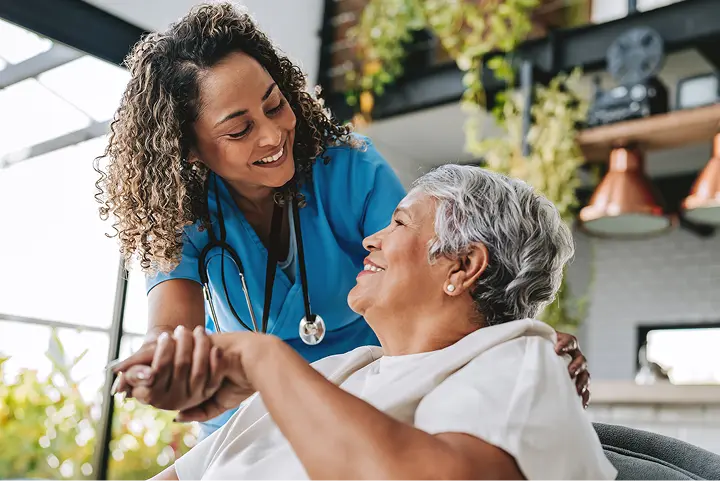 Residents and staff gathered together, sharing a warm moment in a PrimaLiving community.