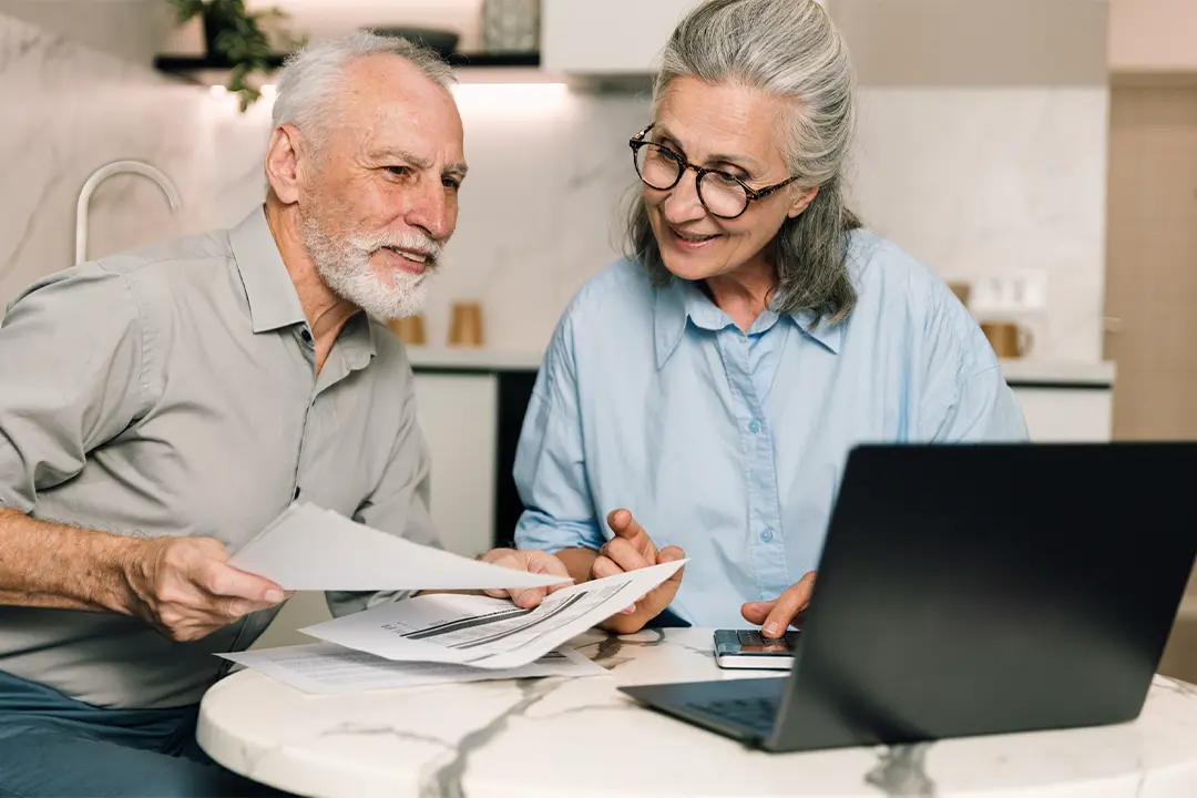 Three residents laughing together in a Prima Living community.